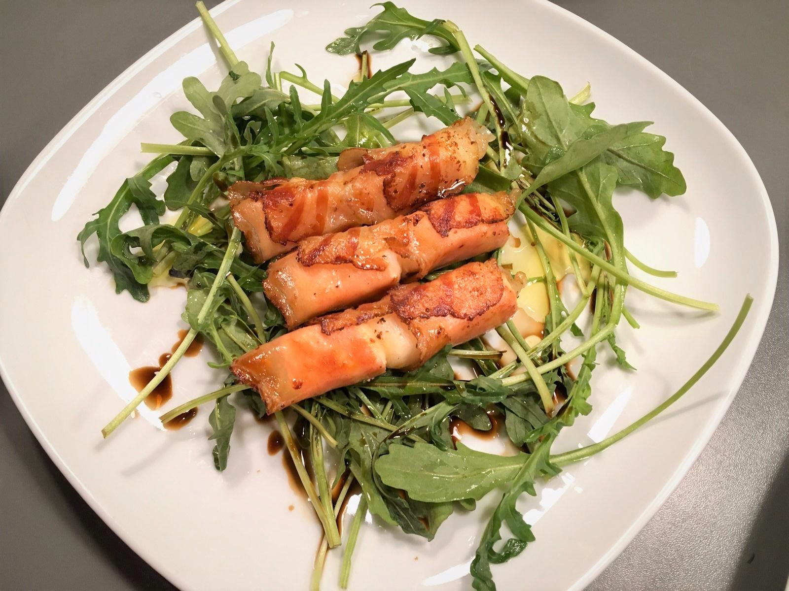 Gebratener Feta im Speckmantel auf Rucola-Salat